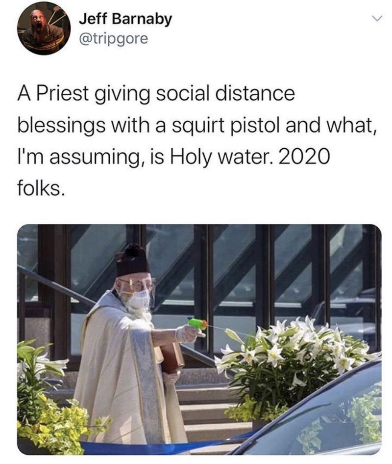 priest giving social distance blessings with a squirt gun